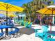 Beachside outdoor dining area with bright umbrellas and chairs, creating a relaxed and inviting atmosphere at 145 50Th St, Holmes Beach, FL 34217
