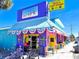 Fun cafe exterior with a whimsical design, and outdoor seating, creating a cheerful atmosphere at 145 50Th St, Holmes Beach, FL 34217