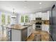 Modern kitchen featuring stainless steel appliances, granite countertops, and a view of the dining area at 145 50Th St, Holmes Beach, FL 34217