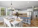 Beautiful kitchen with white cabinetry, granite countertops, and open access to the dining area at 145 50Th St, Holmes Beach, FL 34217