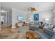 Comfortable living room with neutral tones, ceiling fan, plush seating, and stylish decor at 145 50Th St, Holmes Beach, FL 34217