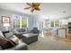Bright open-concept living room with stylish decor and a view of the dining and kitchen areas at 145 50Th St, Holmes Beach, FL 34217