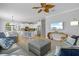 The living room features a coastal aesthetic with a large TV and comfortable seating overlooking the kitchen at 145 50Th St, Holmes Beach, FL 34217