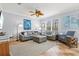 Comfortable living room with neutral tones, ceiling fan, plush seating, and natural light at 145 50Th St, Holmes Beach, FL 34217