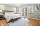 Spacious main bedroom featuring a king bed, hardwood floors, and access to a private balcony at 145 50Th St, Holmes Beach, FL 34217