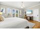 Spacious main bedroom featuring a king bed, hardwood floors, and access to a private balcony at 145 50Th St, Holmes Beach, FL 34217