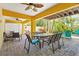 Covered outdoor patio with dining table and chairs overlooking lush backyard at 145 50Th St, Holmes Beach, FL 34217