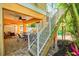 Patio area featuring dining set, stairs to upper floor, and tropical landscaping, creating a relaxing outdoor space at 145 50Th St, Holmes Beach, FL 34217