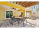 Covered patio with ceiling fan, dining table and chairs, and lounge chairs at 145 50Th St, Holmes Beach, FL 34217