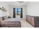 A cozy bedroom with a warm decor and a large window that illuminates the space at 14835 Lyla Ter, Bradenton, FL 34211