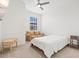 A clean bedroom with an armchair, a window, a ceiling fan, and carpet at 14835 Lyla Ter, Bradenton, FL 34211