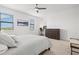 Serene bedroom featuring a ceiling fan, large windows, and an inviting workspace at 14835 Lyla Ter, Bradenton, FL 34211