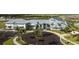 Beautiful view of the clubhouse, surrounded by palm trees, with ample parking in a well-maintained community at 14835 Lyla Ter, Bradenton, FL 34211