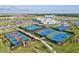 Full view of tennis and pickleball courts plus the clubhouse and a water park, showcasing community amenities at 14835 Lyla Ter, Bradenton, FL 34211