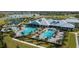 Aerial view of the luxurious community pool, tennis courts, and clubhouse overlooking a scenic lake at 14835 Lyla Ter, Bradenton, FL 34211