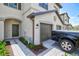 Charming townhome exterior featuring a private garage, gray pavers, and stylish landscaping at 14835 Lyla Ter, Bradenton, FL 34211
