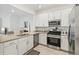A bright, modern kitchen featuring granite countertops and stainless steel appliances at 14835 Lyla Ter, Bradenton, FL 34211