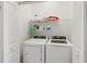 Functional laundry room with a washer, dryer, and shelving for storage at 14835 Lyla Ter, Bradenton, FL 34211