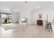 Spacious living room with tile flooring, view of the lake, and plenty of natural light at 14835 Lyla Ter, Bradenton, FL 34211