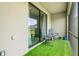 Cozy patio with artificial turf, perfect for outdoor seating and relaxation at 14835 Lyla Ter, Bradenton, FL 34211