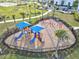 Aerial view of the community playground showing shaded slides, swings, and fenced-in safety at 14835 Lyla Ter, Bradenton, FL 34211