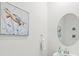 Elegant powder room featuring decorative mirror, modern sink, and turtle themed artwork at 14835 Lyla Ter, Bradenton, FL 34211