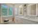 Bright bathroom featuring double sinks, quartz counters, gold fixtures and a window at 1864 Goldenrod St, Sarasota, FL 34239