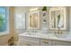 Bathroom featuring double sinks, quartz counters, gold fixtures and a window at 1864 Goldenrod St, Sarasota, FL 34239
