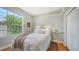 Cozy bedroom with a large window, tray ceiling and a double closet at 1864 Goldenrod St, Sarasota, FL 34239