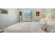 Bedroom with large window, a white wicker bed and neutral walls and floor at 1864 Goldenrod St, Sarasota, FL 34239
