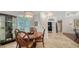 Bright dining room with elegant lighting, view to office and double-door entryway at 1864 Goldenrod St, Sarasota, FL 34239