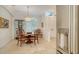 Dining room with wood table, travertine floors, view of front entry and stainless steel refrigerator at 1864 Goldenrod St, Sarasota, FL 34239