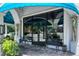 Inviting entrance with black metal benches, potted plants, and an awning at 1864 Goldenrod St, Sarasota, FL 34239