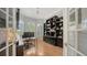 Home office featuring custom built-ins, tray ceilings, and a view to the exterior at 1864 Goldenrod St, Sarasota, FL 34239