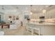 Kitchen featuring marble counters, stainless appliances and white cabinetry open to the living area at 1864 Goldenrod St, Sarasota, FL 34239