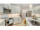 Bright kitchen featuring white cabinets, subway tile backsplash, stainless steel appliances, and an island at 1864 Goldenrod St, Sarasota, FL 34239