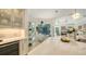 Modern kitchen with white marble countertops and views into the dining area and swimming pool at 1864 Goldenrod St, Sarasota, FL 34239