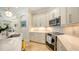 Bright kitchen featuring white cabinets, subway tile backsplash, stainless steel appliances, and an island at 1864 Goldenrod St, Sarasota, FL 34239