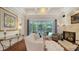 Living room with hardwood floors, fireplace, view of patio and bright, natural light at 1864 Goldenrod St, Sarasota, FL 34239