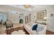 Bright living room features a decorative chandelier, sofa, and view to the home office at 1864 Goldenrod St, Sarasota, FL 34239