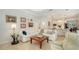 Bright living room featuring a comfortable white sofa, travertine floors and stylish decor at 1864 Goldenrod St, Sarasota, FL 34239