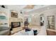 Living room with hardwood floors, fireplace, view of foyer and bright, natural light at 1864 Goldenrod St, Sarasota, FL 34239