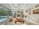 Living room with fireplace, TV, and a bright view to the screened-in pool and backyard at 1864 Goldenrod St, Sarasota, FL 34239
