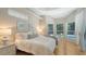 Bright bedroom with a view of the pool area through multiple large windows with wooden floors at 1864 Goldenrod St, Sarasota, FL 34239
