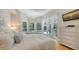 Bright main bedroom with pool view from bay window and patio doors with sheer white curtains at 1864 Goldenrod St, Sarasota, FL 34239