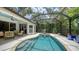 Sparkling pool and spa surrounded by a screened enclosure and lush tropical landscaping at 1864 Goldenrod St, Sarasota, FL 34239