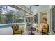 Inviting screened-in pool area with comfortable seating, a spa, and lush landscaping at 1864 Goldenrod St, Sarasota, FL 34239
