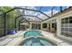 Sparkling pool and spa surrounded by a screened enclosure and lush tropical landscaping at 1864 Goldenrod St, Sarasota, FL 34239