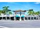 Inviting building exterior with palm trees and bright blue awnings across the entryway at 1864 Goldenrod St, Sarasota, FL 34239