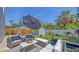 Beautifully designed backyard with patio furniture, lush landscaping, and privacy fence at 2420 Webber St, Sarasota, FL 34239